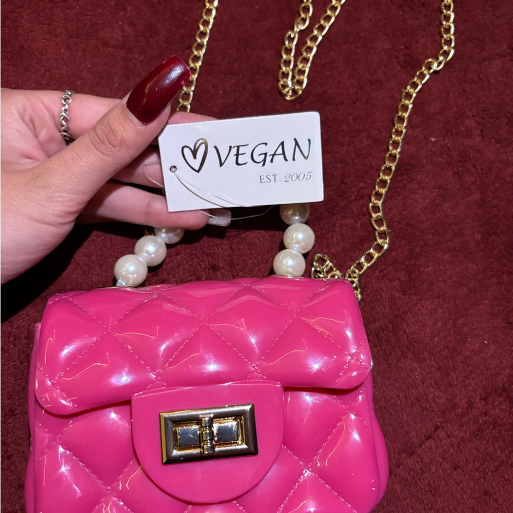 never used. very cute pink mini cross body purse.